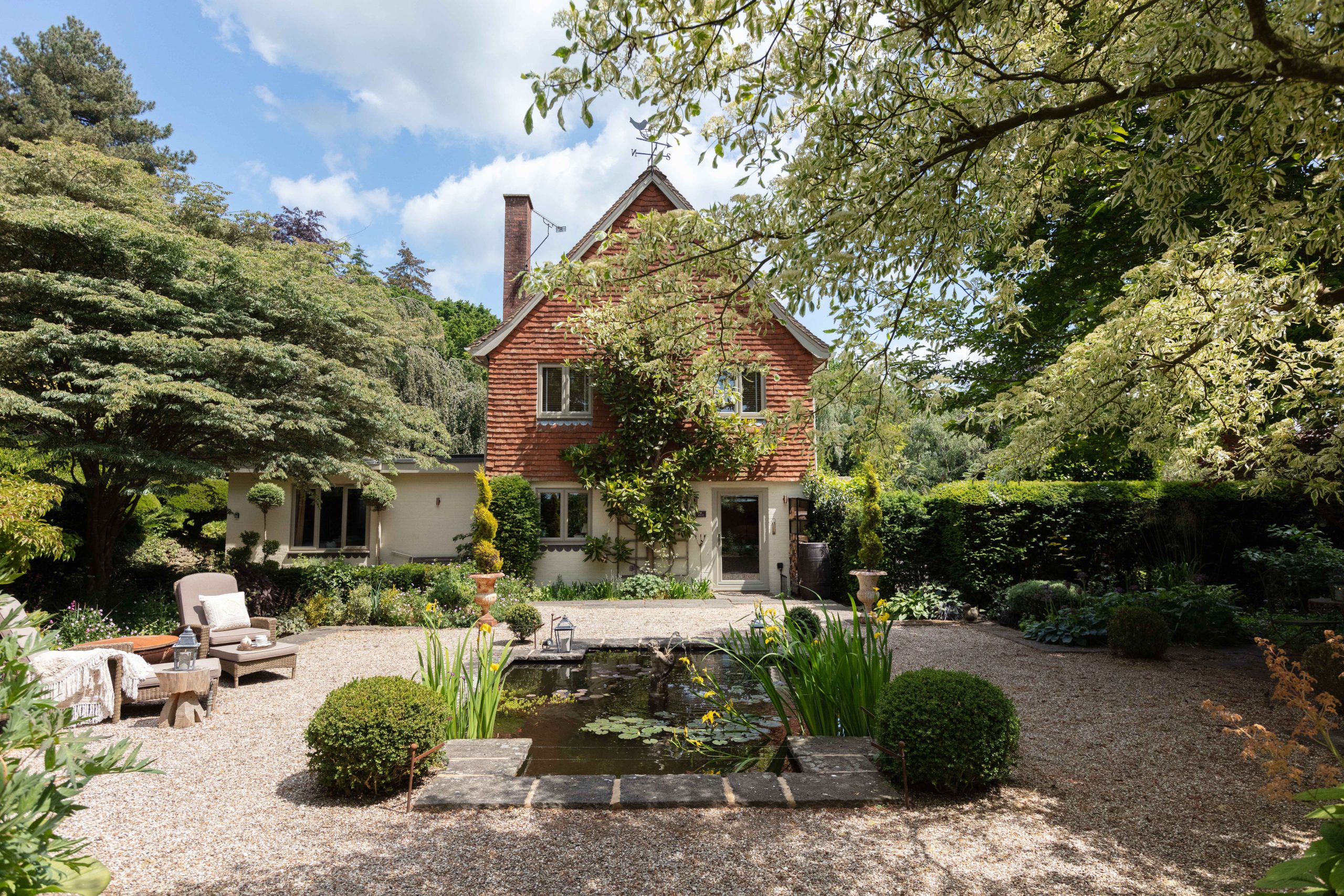 The garden and entrance to the luxury holiday home Nest Cottage in Pulborough, Sussex.