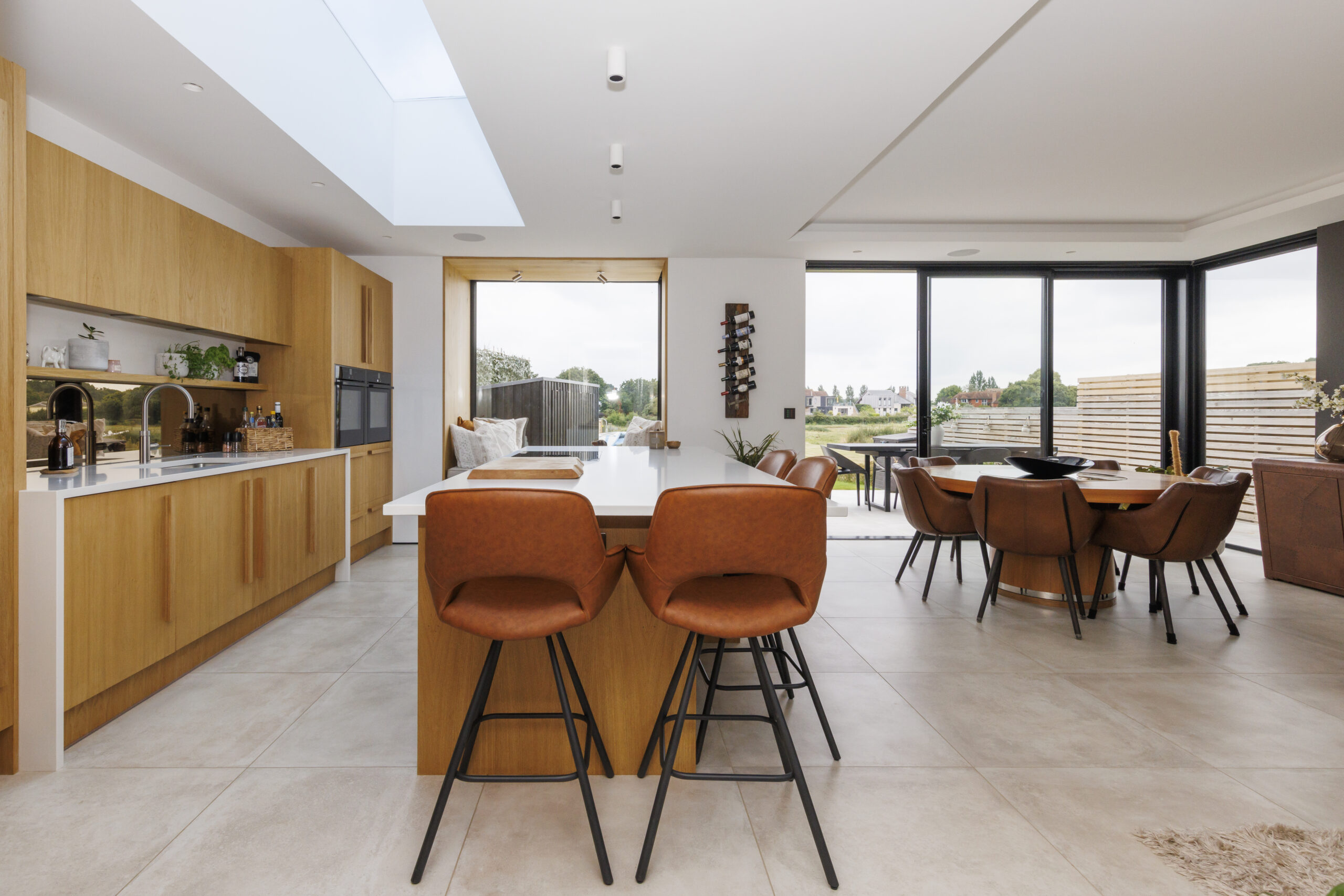 The Black Pearl eco-friendly luxury Sussex holiday home is based in Bosham near Chichester. The image shows the dining area and kitchen of the Black Pearl. 