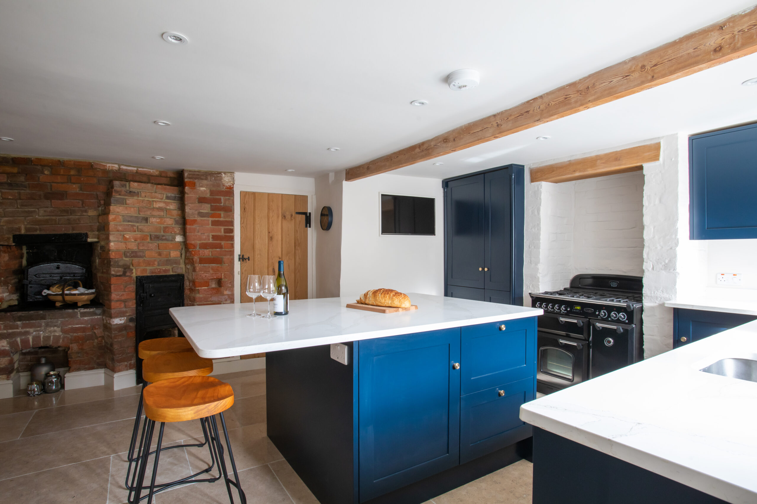 The contemporary and historic kitchen of luxury holiday let The Bakery in Arundel, available to book through The Butler Collection. 