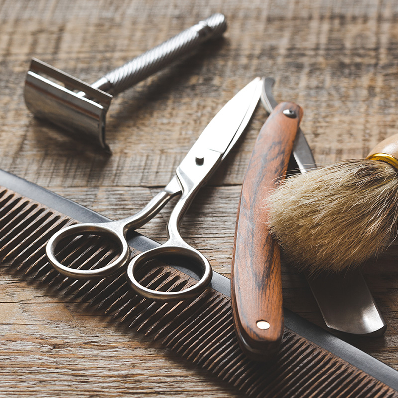 Barber's tools laid out on a table. When you book with The Butler Collection, you can have the barber come to you at your luxury Sussex holiday home.