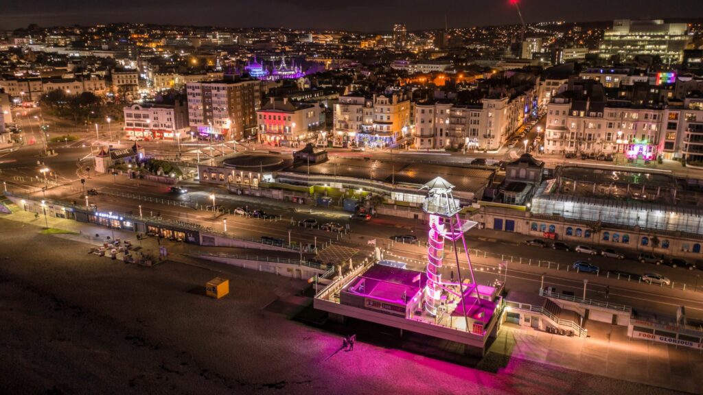 A night shot of Brighton seafront lit up during a weekend in Brighton