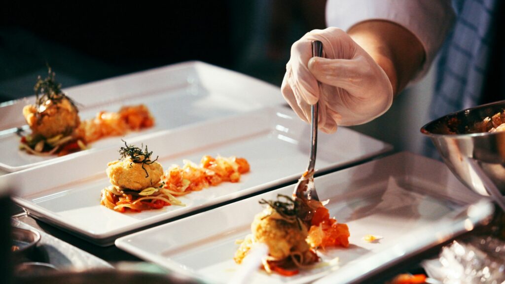 Private chef in Sussex. Image shows a private chef serving up a plate of food for guests
