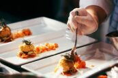 Private chef in Sussex. Image shows a private chef serving up a plate of food for guests