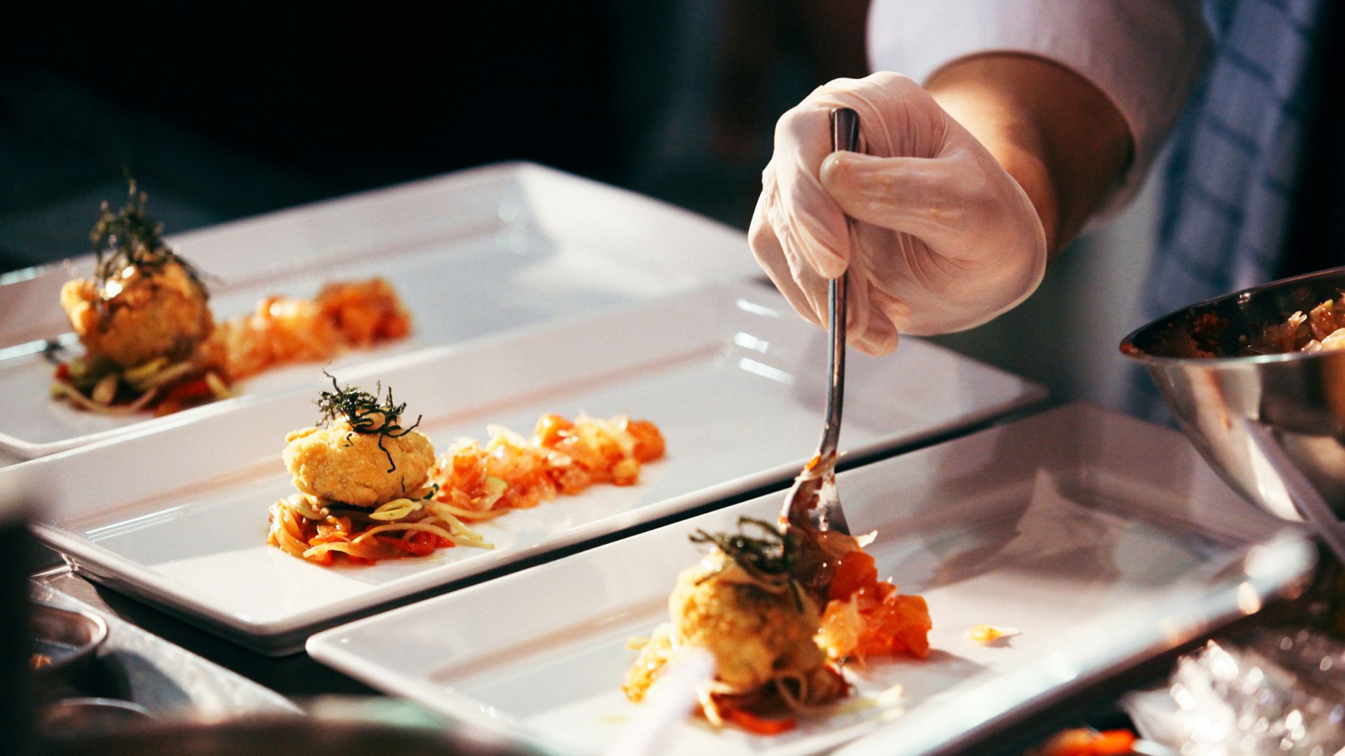 Private chef in Sussex. Image shows a private chef serving up a plate of food for guests